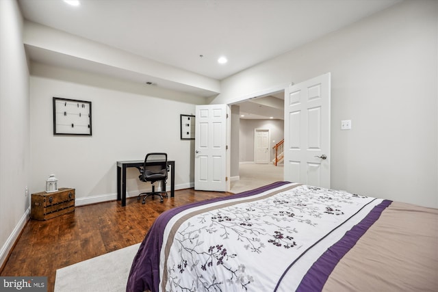 bedroom with baseboards, wood finished floors, and recessed lighting