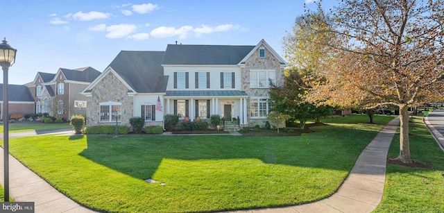 view of front facade with a front yard and stone siding