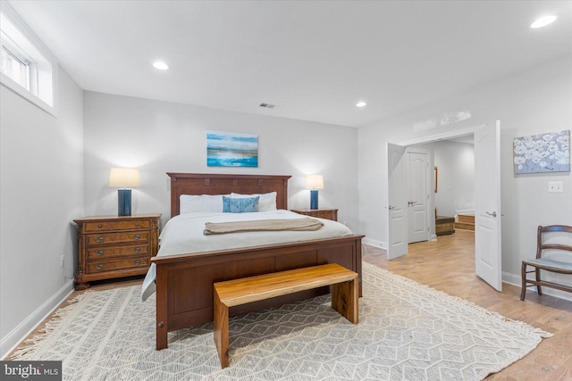 bedroom featuring baseboards, light wood finished floors, visible vents, and recessed lighting