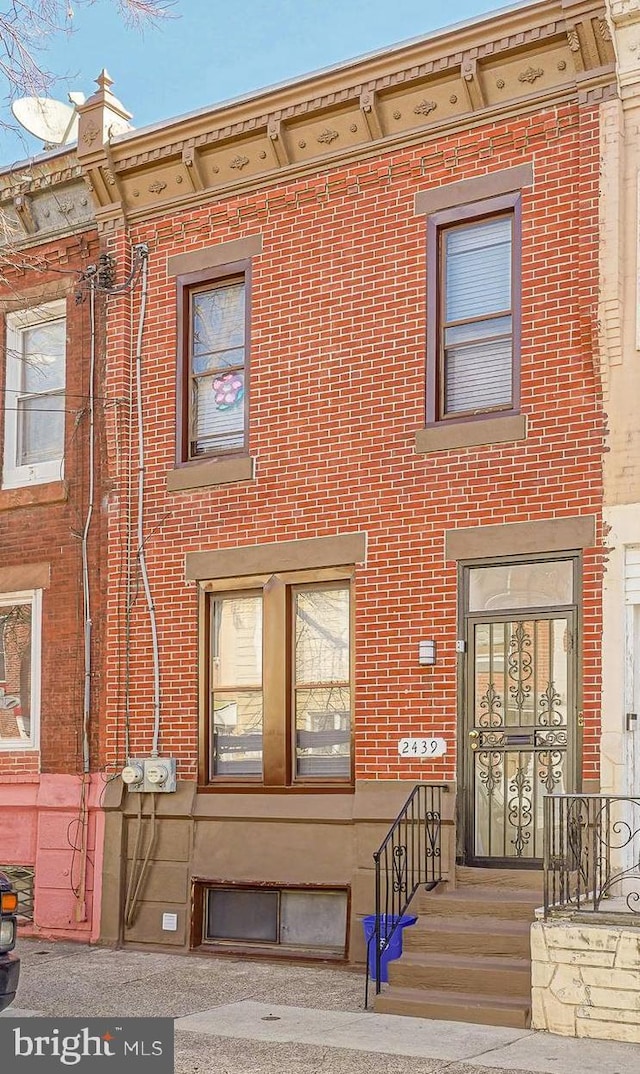 view of front of house featuring brick siding