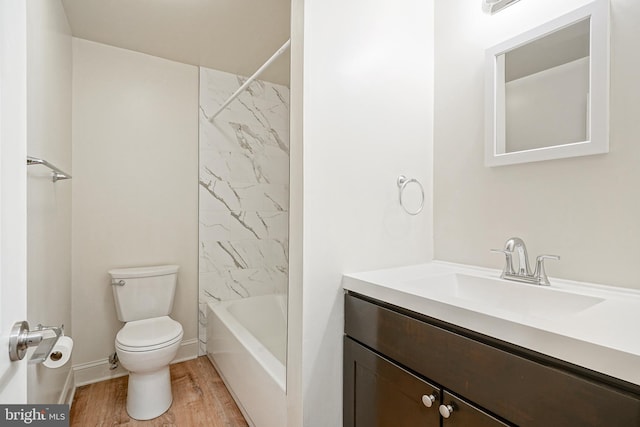 bathroom featuring vanity, shower / tub combination, wood finished floors, and toilet