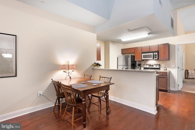 dining area featuring dark wood-style floors, visible vents, and baseboards