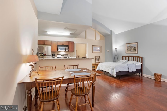 bedroom featuring lofted ceiling, dark wood-style floors, baseboards, and freestanding refrigerator