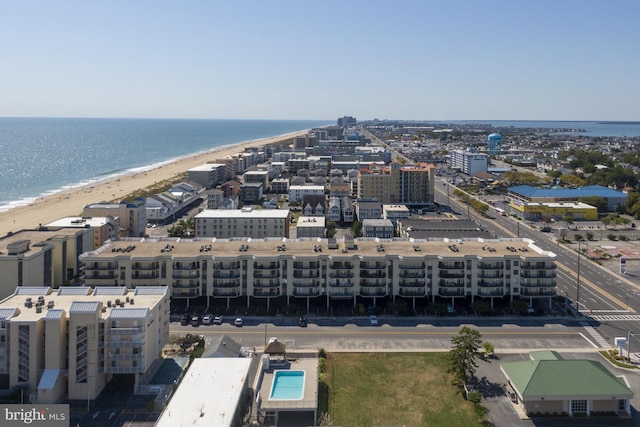 drone / aerial view featuring a city view, a beach view, and a water view