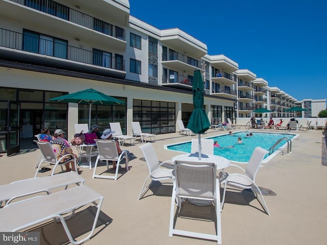 community pool featuring a patio area