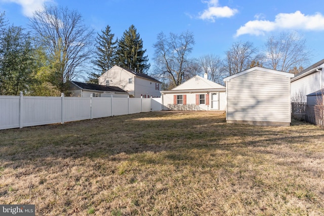 view of yard featuring an outbuilding and a fenced backyard