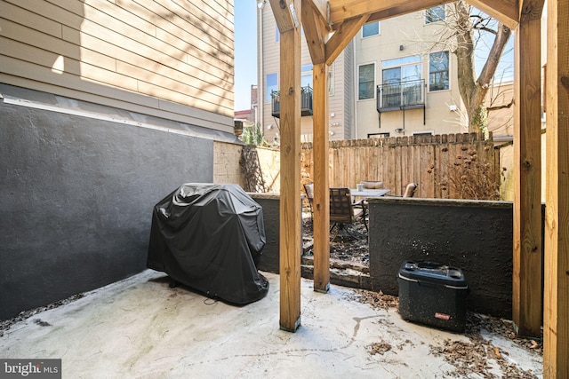 view of patio / terrace with a grill and fence