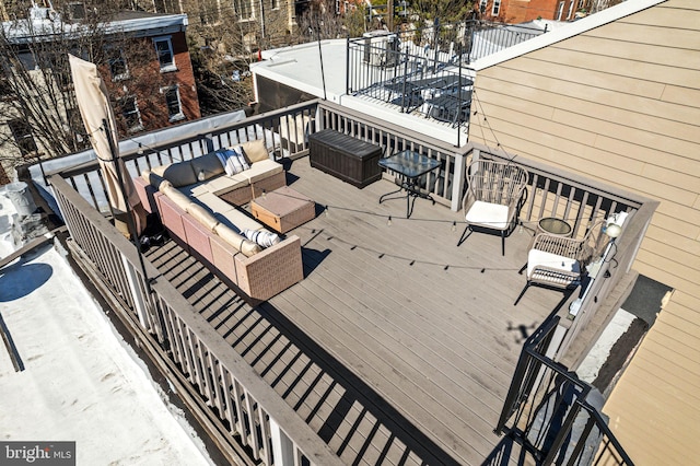 wooden terrace with an outdoor hangout area