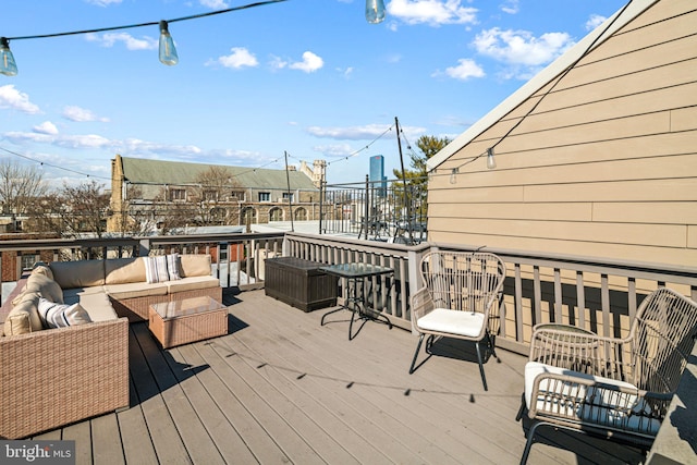 wooden terrace with an outdoor hangout area