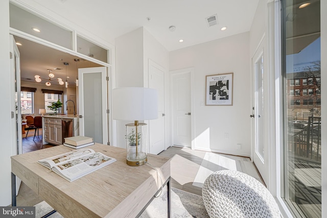 dining room with light wood-style floors, recessed lighting, and visible vents