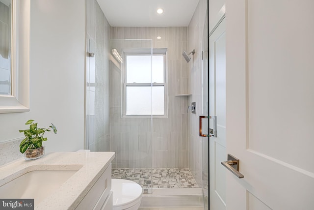 bathroom featuring a stall shower, vanity, toilet, and recessed lighting