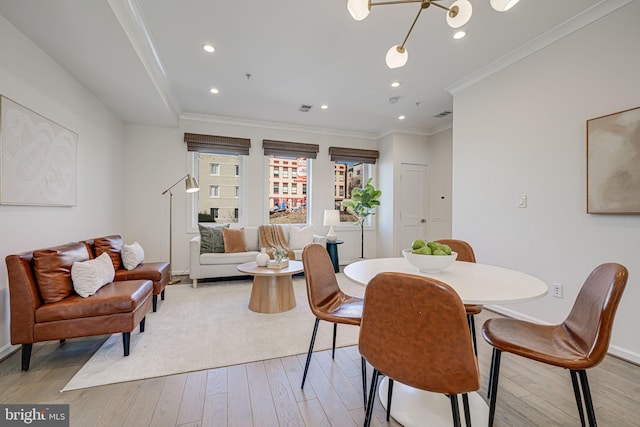 dining area with recessed lighting, light wood-type flooring, visible vents, and crown molding