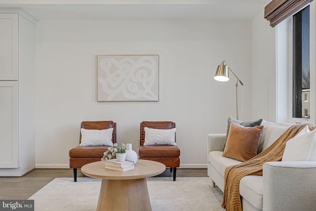 sitting room with light wood-style flooring and baseboards