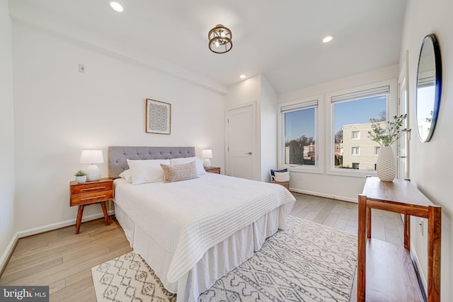 bedroom with light wood-style floors, baseboards, and recessed lighting