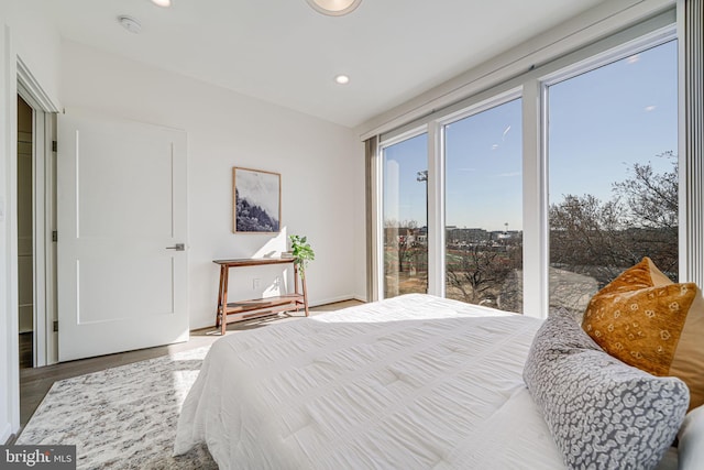 bedroom featuring wood finished floors and recessed lighting