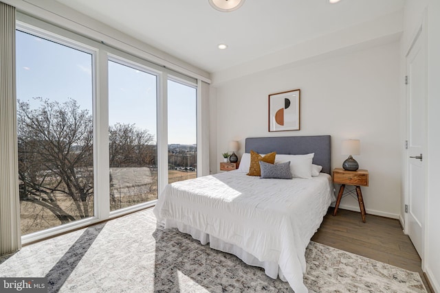 bedroom with recessed lighting, baseboards, and wood finished floors