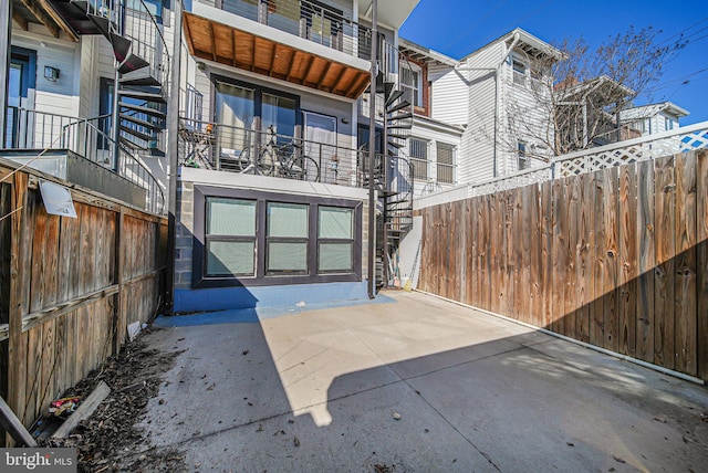 rear view of house featuring a patio and fence