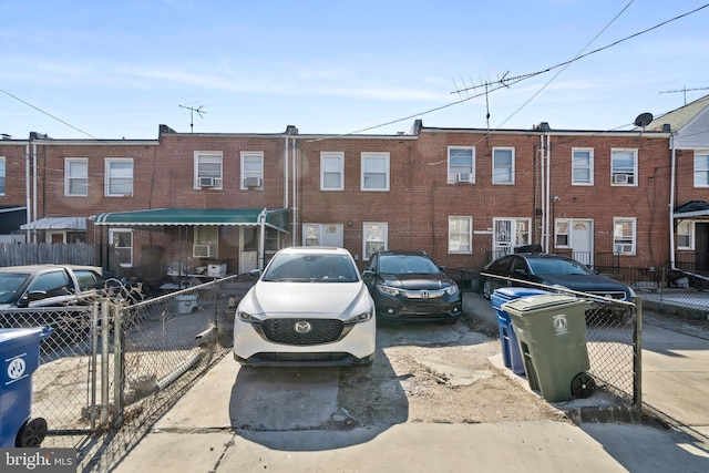 view of parking / parking lot with fence