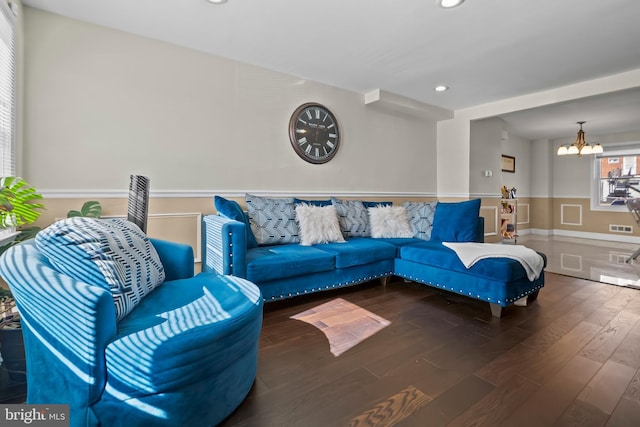 living area featuring a wainscoted wall, recessed lighting, visible vents, wood finished floors, and a chandelier