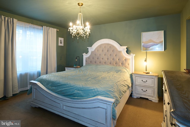 bedroom with multiple windows, dark colored carpet, and a notable chandelier