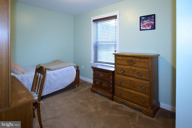 bedroom with carpet floors and baseboards