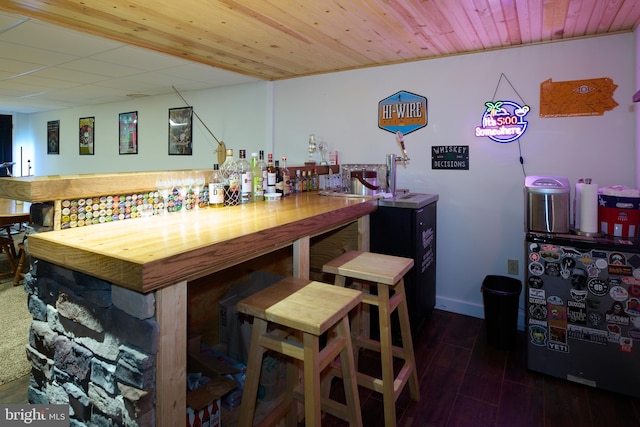 bar with wood ceiling, dark wood-style flooring, baseboards, and a dry bar