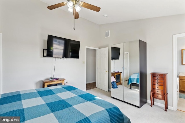 bedroom featuring light carpet, visible vents, ceiling fan, vaulted ceiling, and a closet