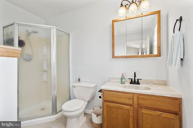 bathroom with a stall shower, vanity, toilet, and tile patterned floors