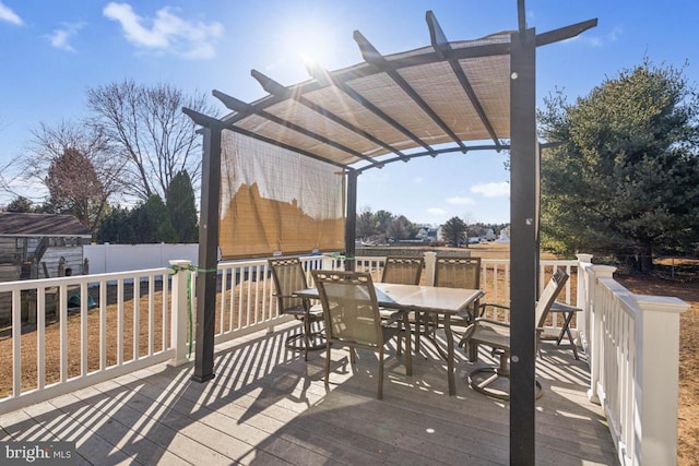 deck with outdoor dining space, fence, and a pergola