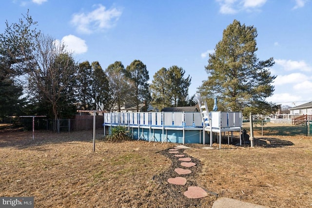 back of house with fence and a fenced in pool