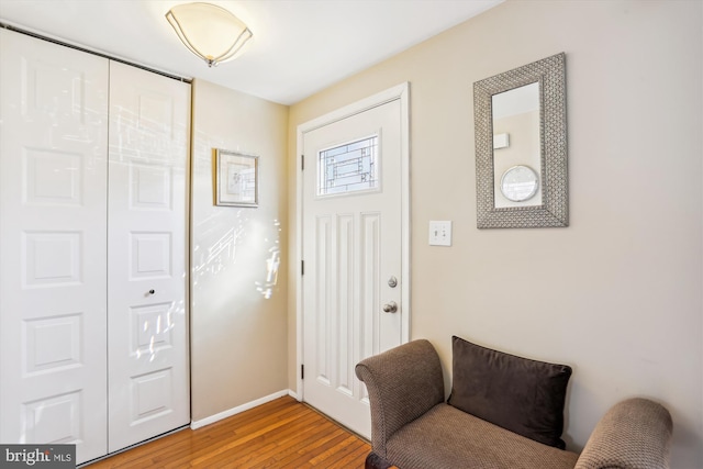 foyer entrance featuring light wood-style flooring and baseboards