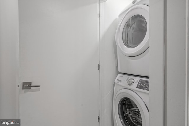 clothes washing area with laundry area and stacked washer and clothes dryer