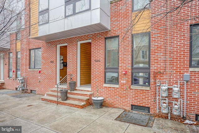 property entrance with brick siding