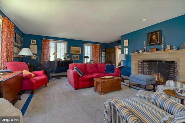 living area with carpet floors and a lit fireplace