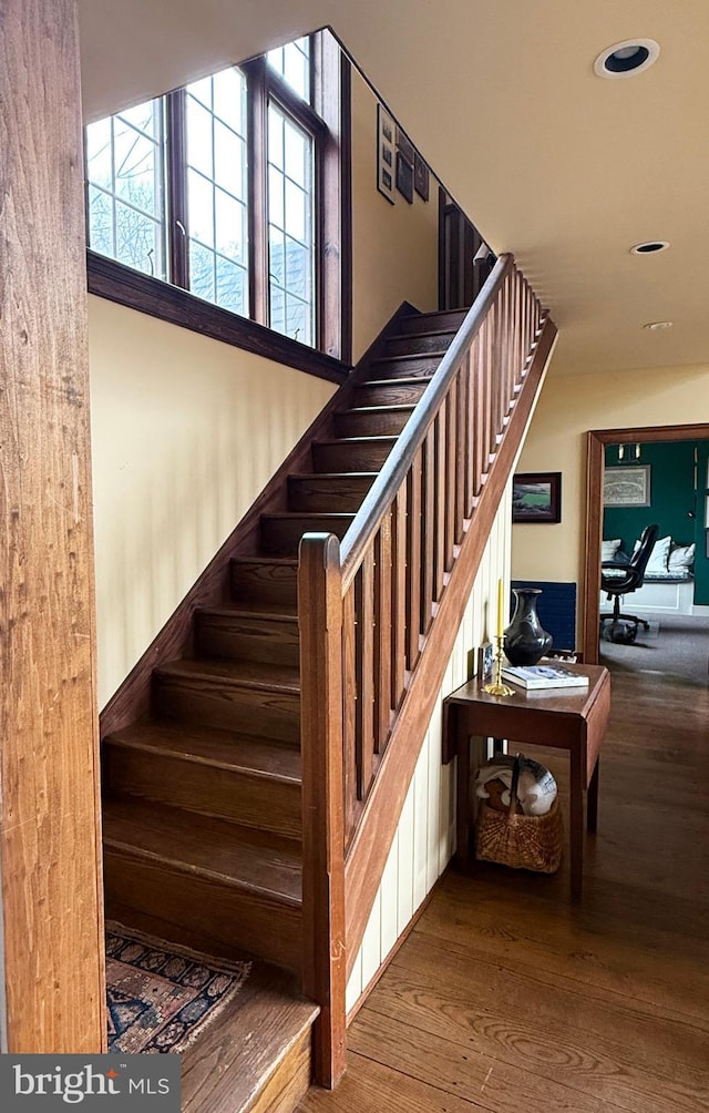 stairs featuring wood-type flooring and recessed lighting