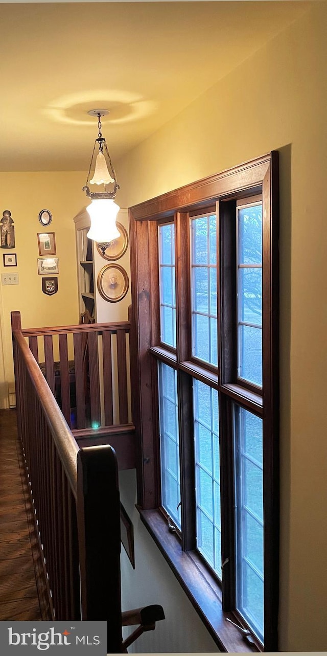 interior space featuring dark wood-style flooring and an upstairs landing