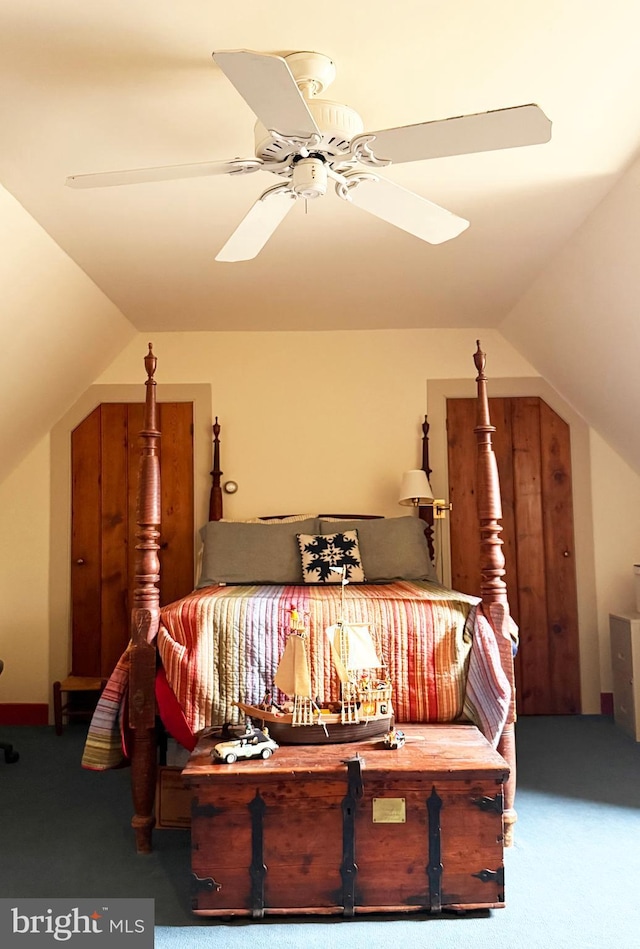 carpeted bedroom with lofted ceiling