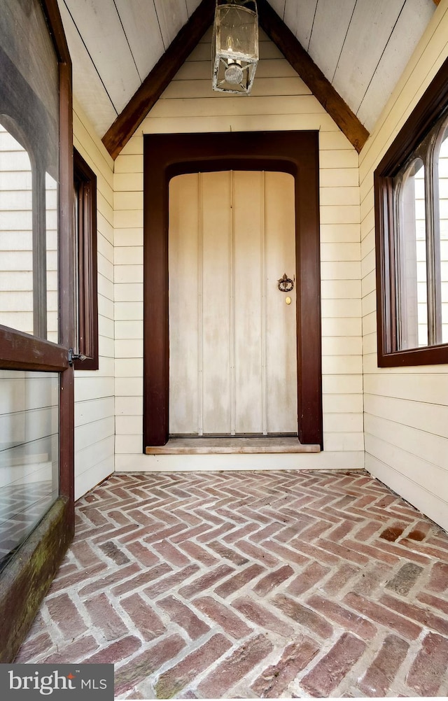 view of exterior entry featuring a porch