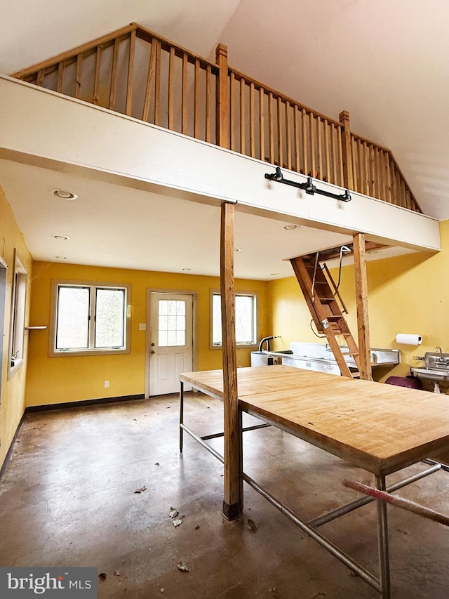 interior space with concrete flooring and a high ceiling