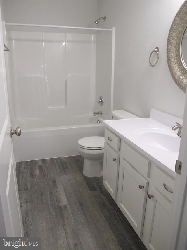 full bathroom featuring bathing tub / shower combination, vanity, toilet, and wood finished floors