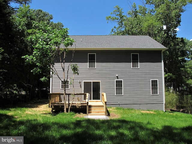 back of house with a deck and a yard