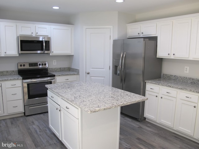 kitchen featuring stainless steel appliances, white cabinets, and a kitchen island