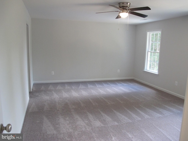 unfurnished room with carpet, a ceiling fan, and baseboards