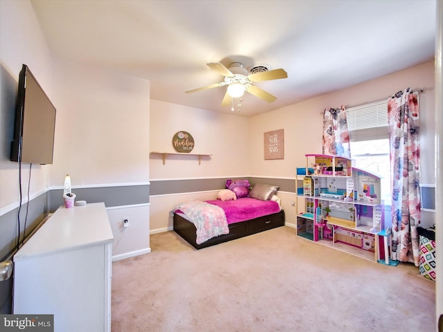 bedroom with a ceiling fan and carpet