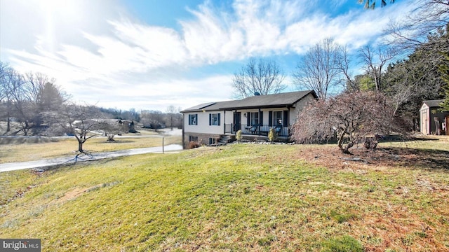 view of front of house with roof mounted solar panels, covered porch, and a front lawn