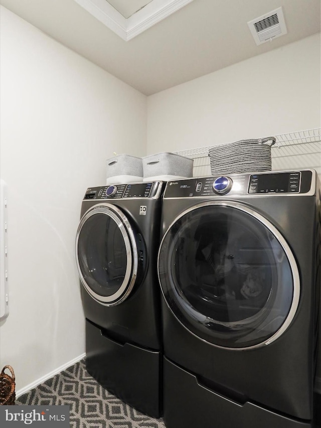 laundry room with laundry area, baseboards, visible vents, carpet flooring, and separate washer and dryer