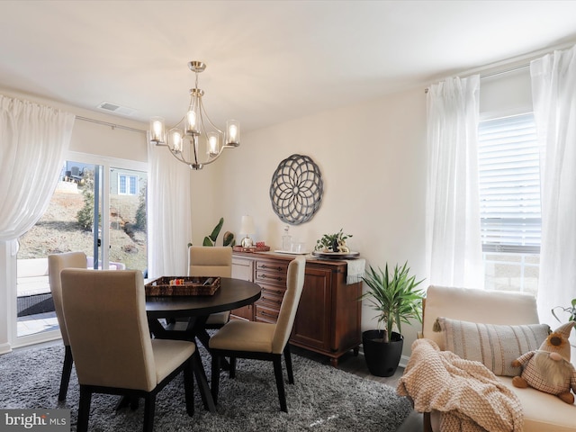 dining area with visible vents and a notable chandelier