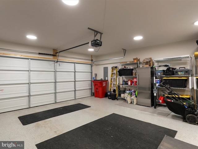 garage featuring recessed lighting, electric panel, and a garage door opener