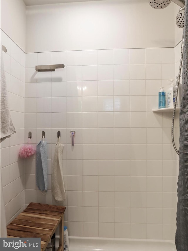 full bath with a tile shower