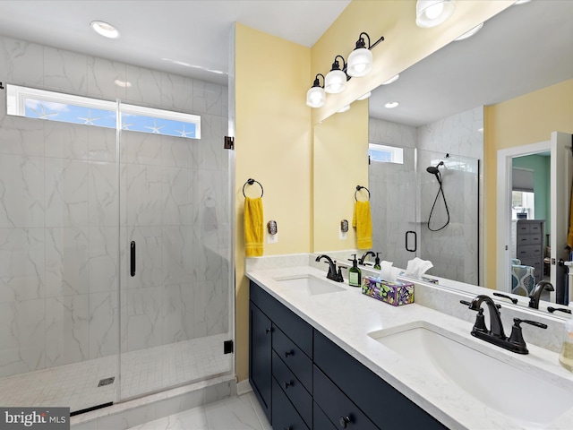 bathroom featuring marble finish floor, a sink, a marble finish shower, and double vanity